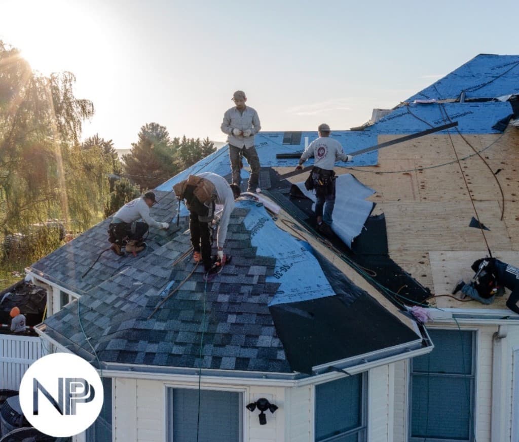 New Paradigm Projects team on a completed roof